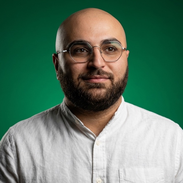 Mohammed Hakmi, in a white shirt and glasses